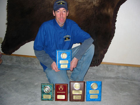 John Simmons at home with his plaques